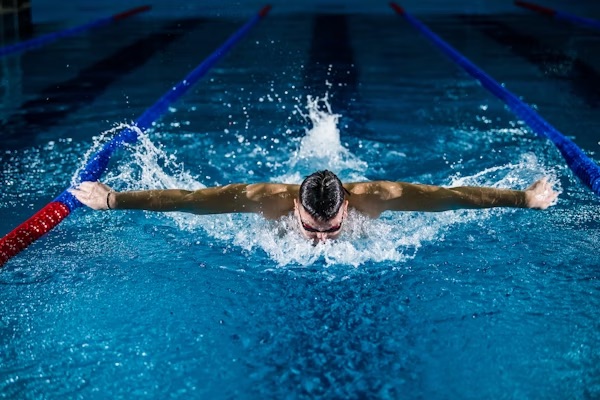 Competitive swimmer doing butterfly stroke